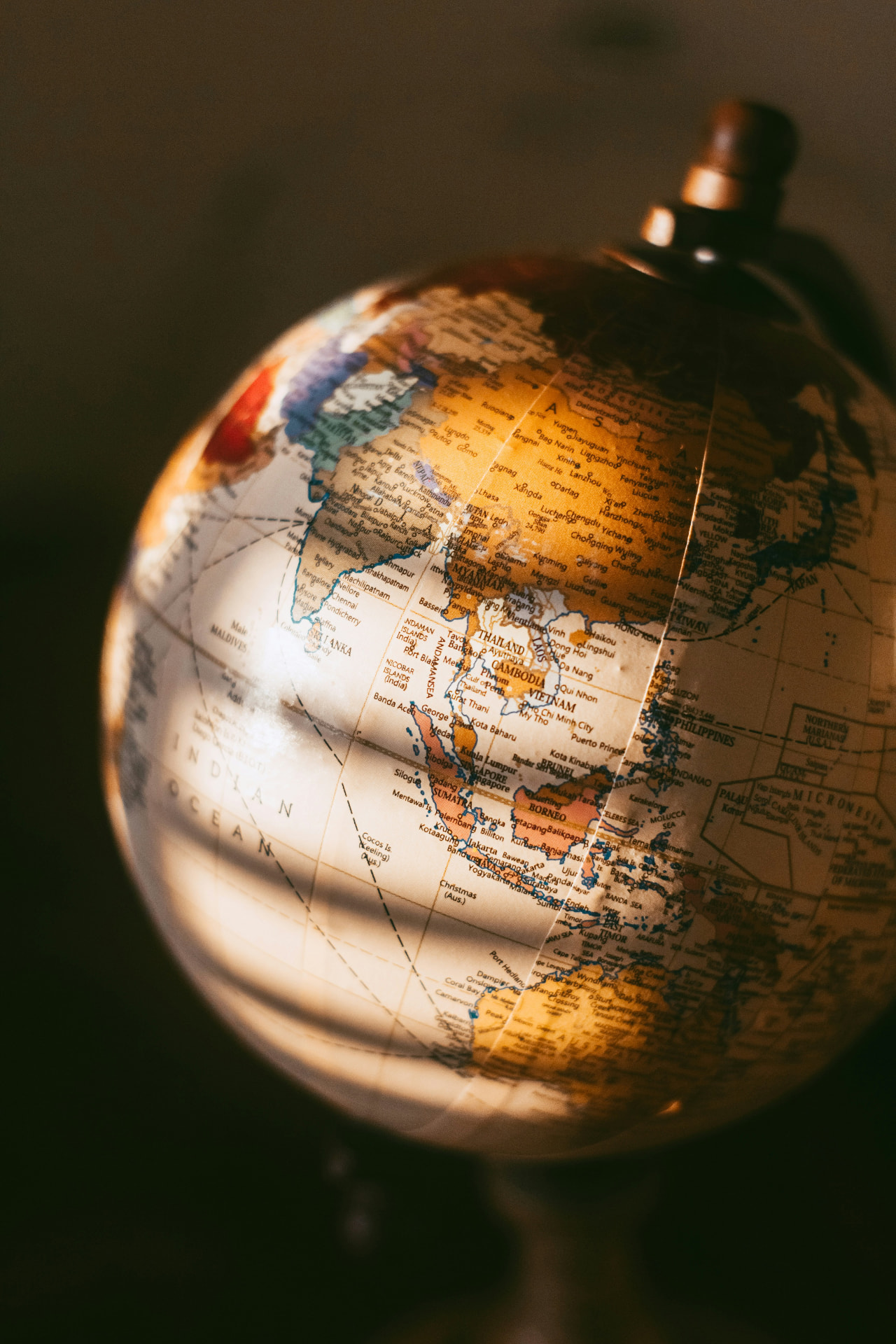 Warm amber-lit globe representing international re-validation of Extended DISC